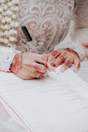 a picture of a person signing a document